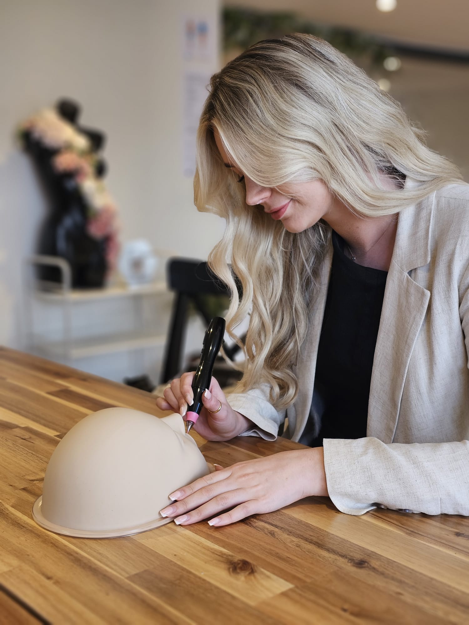 Tayla practising injectable technique on a training head